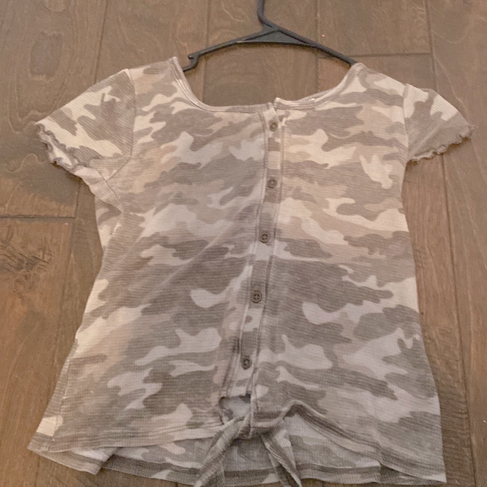 I am selling a shirt that is green And the brand is justice.